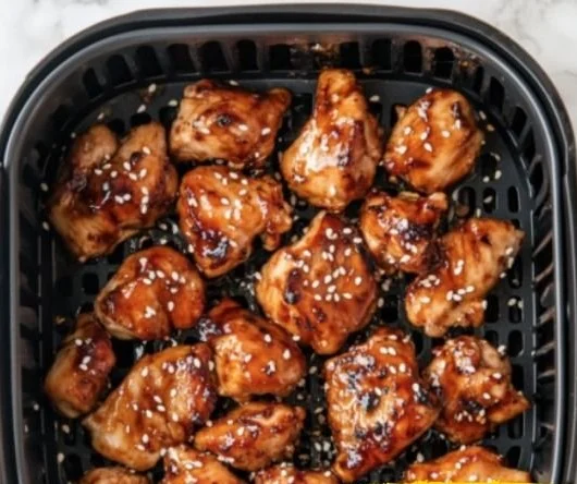 Air Fryer Teriyaki Chicken plated with sesame seeds and green onions