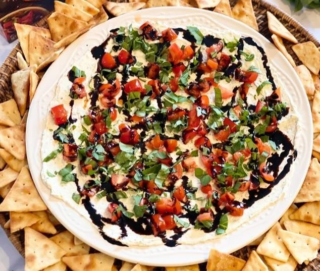 Delicious and fresh Bruschetta Dip served in a bowl with toasted bread.