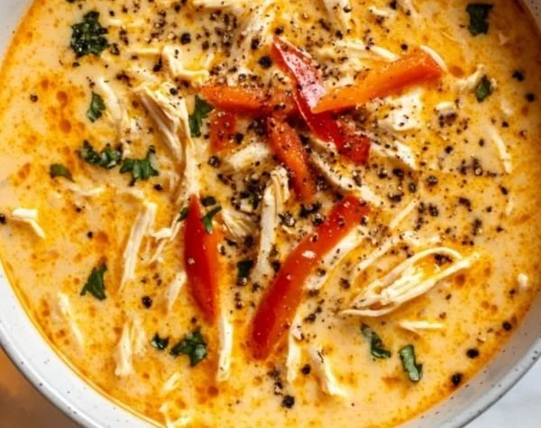 Creamy Cajun Chicken Soup with spices and vegetables in a bowl