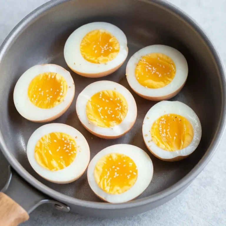 A close-up of soft-boiled eggs with perfectly runny yolks served in egg cups.